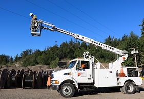 Utility worker completing an aerial installation